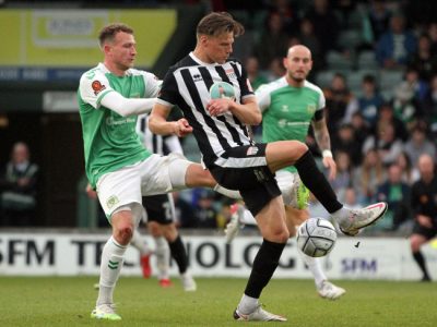 Bath City No. 9 Cody Cooke tries to grapple hold of the ball.